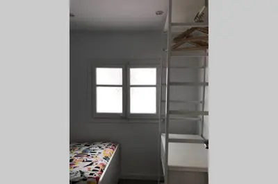 a bedroom with a bunk bed and a ladder at M3 Terrace. Cool apartment 15 min center by metro in Esplugues de Llobregat