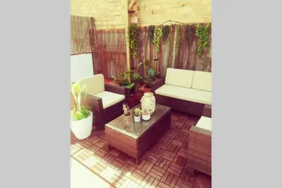 a patio with a couch and a table at M3 Terrace. Cool apartment 15 min center by metro in Esplugues de Llobregat