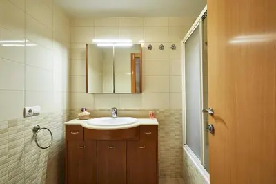 a bathroom with a sink and a mirror at BBarcelona Marina Flat in Barcelona