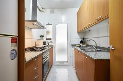 a small kitchen with a sink and a stove at BBarcelona Marina Flat in Barcelona