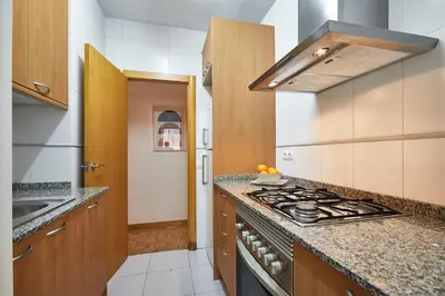 a kitchen with a stove and a counter top at BBarcelona Marina Flat in Barcelona