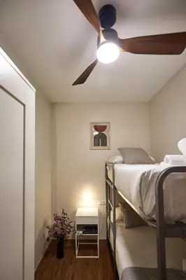 a bedroom with a ceiling fan and a bed at BBarcelona Marina Flat in Barcelona