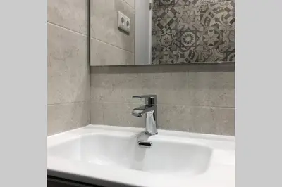 a bathroom sink with a faucet and a mirror at M5 Cool Terrace. Metro 1 min. Center 15' by metro in Esplugues de Llobregat