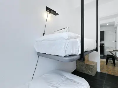 a bedroom with two twin beds and a mirror at Casa nanit apt a in Hospitalet de Llobregat