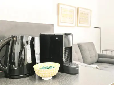 a kitchen counter with a coffee maker and a microwave at Casa nanit apt a in Hospitalet de Llobregat