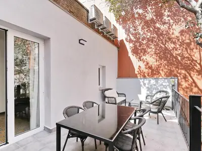 a patio with chairs and a table on a balcony at Casa nanit apt c in Hospitalet de Llobregat