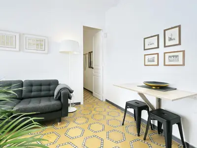 a living room with a couch and a table and stools at Casa nanit apt d in Hospitalet de Llobregat