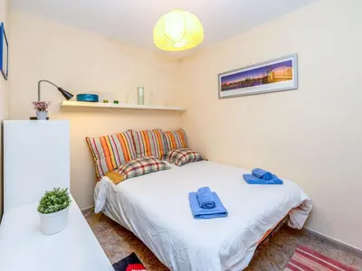 a small bedroom with a bed with towels on it at Apartment Camp Nou by Interhome in Barcelona