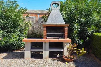 a small bird house sitting in a garden at Masia Cal Tonarro in San Martín Sarroca