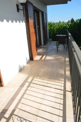 a balcony of a house with a table on it at Masia Cal Tonarro in San Martín Sarroca