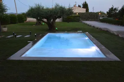 a swimming pool in the middle of a yard at Masia Cal Tonarro in San Martín Sarroca