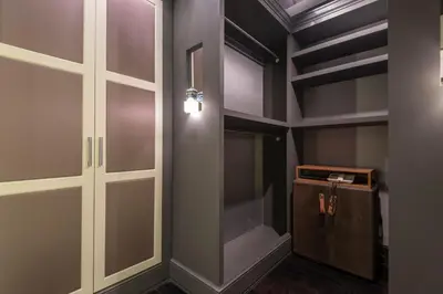 a walk in closet with glass doors and a wooden cabinet at SuiteaBcn II in Barcelona