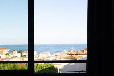 a view of the ocean from a window at Apartaments Voralmar in Caldes d'Estrac