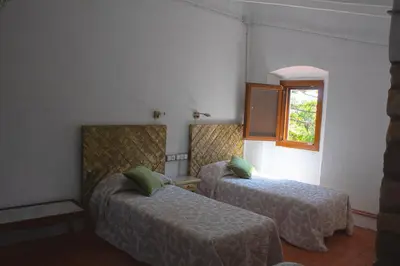 a hotel room with two beds and a window at Romegosa Benestar in Sant Marçal