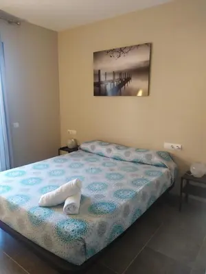 a bedroom with a bed with a towel on it at Apartamento Arenys de Munt - Costa Barcelona, Maresme - in Arenys de Munt