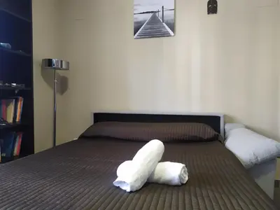 a white stuffed animal laying on a bed at Apartamento Arenys de Munt - Costa Barcelona, Maresme - in Arenys de Munt