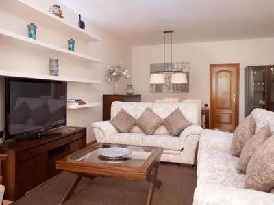 a living room with a couch and a tv at Click&Flat Luxury mistral in Barcelona