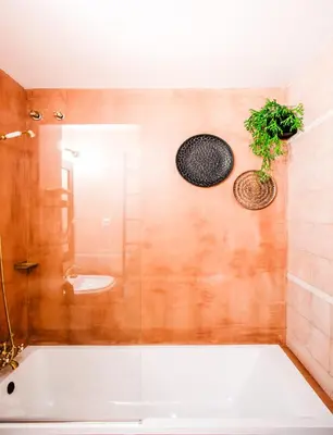 a bathroom with a tub and a sink and a toilet at 1840 Apartments Sitges by Suma Hotels in Sitges