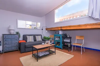 a living room with a couch and a table at 1840 Apartments Sitges by Suma Hotels in Sitges
