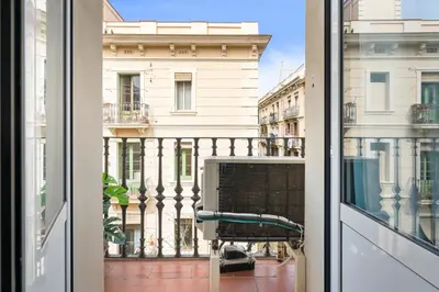an open window with a view of a building at Lodging Apartments Barceloneta Beach Studio 31 in Barcelona