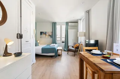 a living room with a bed and a dining room at Lodging Apartments Barceloneta Beach Studio 31 in Barcelona
