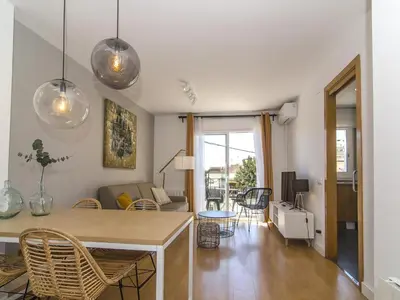 a kitchen and living room with a table and chairs at Sitges Spaces Terrace Apartment- 1 Bedroom, 1Bathroom, Huge Terrace in Sitges
