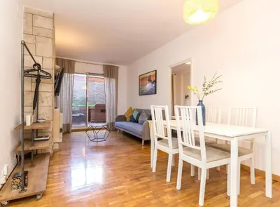 a dining room and living room with a table and chairs at Find Calm at this cozy City Sanctuary with terrace in Barcelona