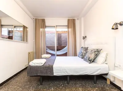 a small bedroom with a bed and a window at Find Calm at this cozy City Sanctuary with terrace in Barcelona