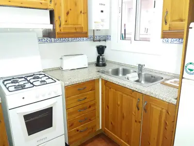 a kitchen with a stove and a sink at Apartamento Sagrada Familia in Barcelona