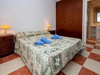 a bedroom with a bed with blue pillows on it at Apartment Sun and Beach by Interhome in Cunit