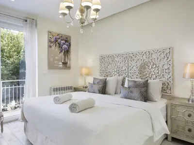 a bedroom with a large white bed with two pillows on it at Sitges Spaces Mediterranean Apartments 5 Bedrooms, 4 Bathrooms, 75M2 Terrace, Centre Sitges- Sleeps 11 in Sitges
