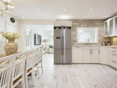 a kitchen with a refrigerator and a table and chairs at Sitges Spaces Mediterranean Apartments 5 Bedrooms, 4 Bathrooms, 75M2 Terrace, Centre Sitges- Sleeps 11 in Sitges