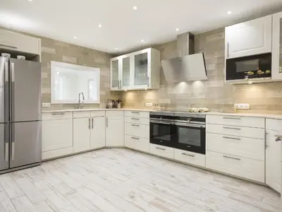 a kitchen with white cabinets and stainless steel appliances at Sitges Spaces Mediterranean Apartments 5 Bedrooms, 4 Bathrooms, 75M2 Terrace, Centre Sitges- Sleeps 11 in Sitges
