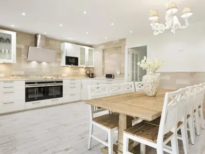 a kitchen with a wooden table and a vase of flowers at Sitges Spaces Mediterranean Apartments 5 Bedrooms, 4 Bathrooms, 75M2 Terrace, Centre Sitges- Sleeps 11 in Sitges