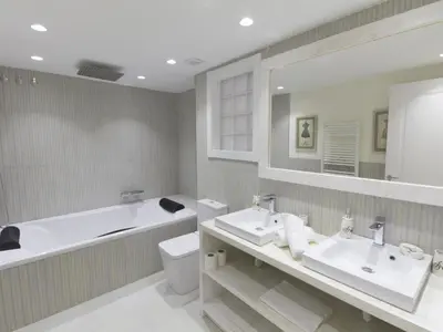 a bathroom with two sinks and a tub and a toilet at Sitges Spaces Mediterranean Apartments 5 Bedrooms, 4 Bathrooms, 75M2 Terrace, Centre Sitges- Sleeps 11 in Sitges