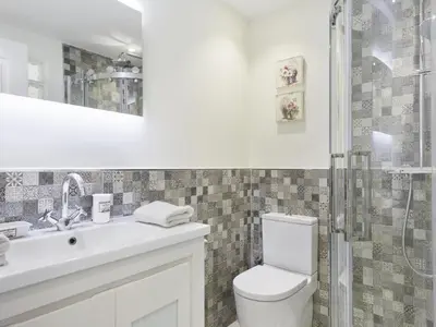 a bathroom with a toilet and a sink and a shower at Sitges Spaces Mediterranean Apartments 5 Bedrooms, 4 Bathrooms, 75M2 Terrace, Centre Sitges- Sleeps 11 in Sitges