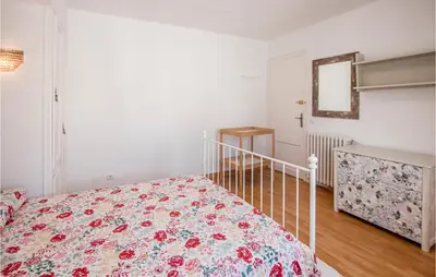 a bedroom with a bed with a floral bedspread at 5 Bedroom Awesome Home In Alella in Alella