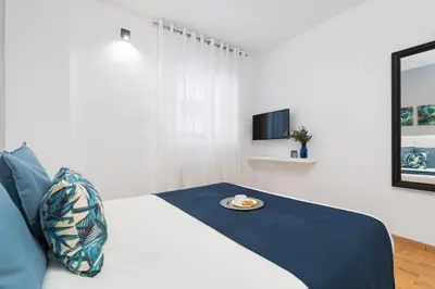 a bedroom with a bed with a plate on it at Lodging Apartments Villa de Gracia 2 bedroom cozy apartment in Barcelona