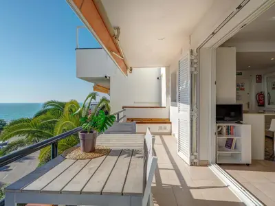 a balcony with a table and a view of the ocean at Balmins White by Hello Homes Sitges in Sitges