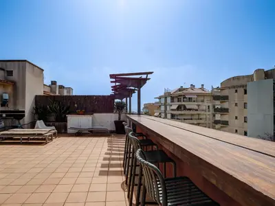a row of chairs sitting on top of a roof at Los Condes Penthouse by Hello Homes Sitges in Sitges