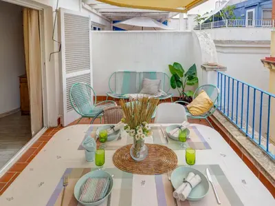 a patio with a table and chairs on a balcony at Velero Attic by Hello Homes Sitges in Sitges