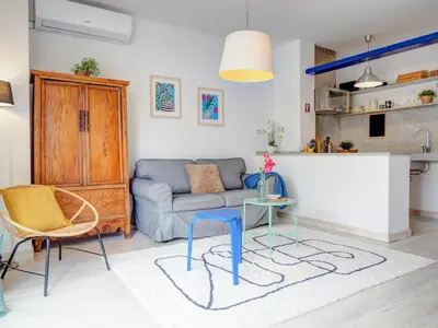 a living room with a couch and a table at Velero Attic by Hello Homes Sitges in Sitges