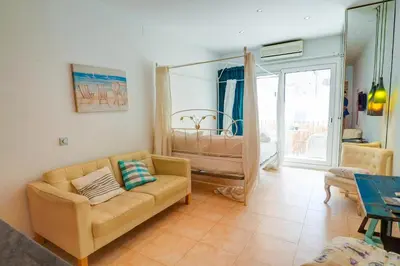 a living room with a couch and a crib at The Loft by Hello Homes Sitges in Sitges