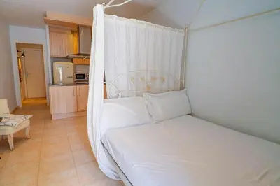 a bed with a white canopy in a room at The Loft by Hello Homes Sitges in Sitges