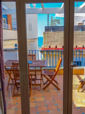 a patio with a table and chairs on a balcony at Barco Attic by Hello Homes Sitges in Sitges