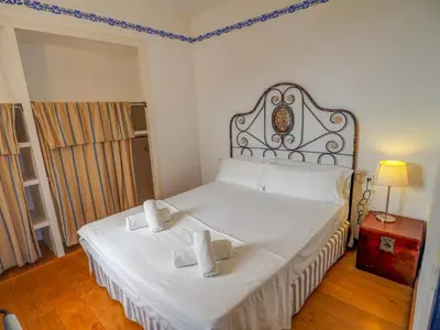 a bedroom with a large white bed with a headboard at Barco Attic by Hello Homes Sitges in Sitges