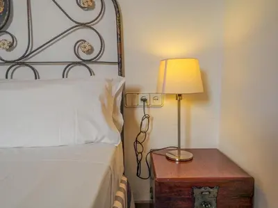 a bedroom with a bed and a lamp on a table at Barco Attic by Hello Homes Sitges in Sitges