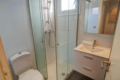 a bathroom with a shower and a toilet and a sink at Harbour terraces by Hello Homes Sitges in Sitges