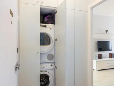 a laundry room with a washer and dryer at Click&Flat Xoriguer in Barcelona