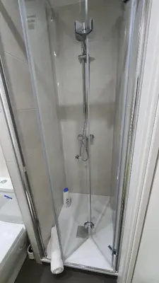 a shower in a bathroom with a glass door at Opening Doors Sagrada Familia in Barcelona